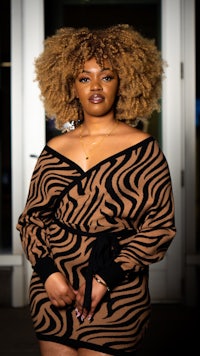 a woman in a zebra print dress posing for a photo