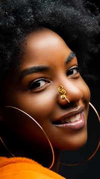 a woman with a nose piercing smiling